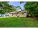 Brick home featuring a cozy front porch and a well-maintained green lawn at 1116 Jadewood Ave, Clearwater, FL 33759