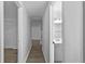 Hallway view leads to rooms with wood-look floors and neutral paint at 1116 Jadewood Ave, Clearwater, FL 33759