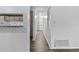 Bright hallway with wood floors, white walls, and a view into an open kitchen with bar seating at 1116 Jadewood Ave, Clearwater, FL 33759