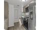 Modern kitchen featuring stainless steel appliances, gray cabinets and granite counters at 1116 Jadewood Ave, Clearwater, FL 33759