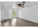 The well lit living room features a ceiling fan and light plank flooring at 1116 Jadewood Ave, Clearwater, FL 33759
