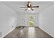 Living room featuring ceiling fan and plank flooring at 1116 Jadewood Ave, Clearwater, FL 33759