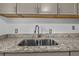 Close-up of kitchen sink with granite countertops and stainless steel faucet at 1116 Jadewood Ave, Clearwater, FL 33759