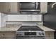 New stainless steel stove top with gray and stainless microwave oven above at 1116 Jadewood Ave, Clearwater, FL 33759