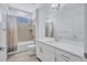 Clean bathroom featuring a white vanity, large mirror, and a bathtub with shower at 1119 Highland S St, St Petersburg, FL 33701