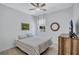 Cozy bedroom featuring a ceiling fan, wooden floors, and a comfortable bed with soft lighting at 1119 Highland S St, St Petersburg, FL 33701