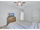 Comfortable bedroom with a wooden dresser, ceiling fan and wood flooring throughout at 1119 Highland S St, St Petersburg, FL 33701