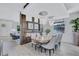 Open dining room with decorative columns and view to living room at 1119 Highland S St, St Petersburg, FL 33701