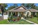 Charming home with manicured landscaping, a covered porch, and decorative shutters at 1119 Highland S St, St Petersburg, FL 33701