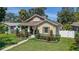 Charming home with manicured landscaping, a covered porch, and decorative shutters at 1119 Highland S St, St Petersburg, FL 33701