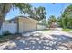 Exterior view of a one-car garage with a driveway and white privacy fence at 1119 Highland S St, St Petersburg, FL 33701