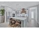 Bright kitchen featuring an island with seating, stainless appliances, and white cabinets at 1119 Highland S St, St Petersburg, FL 33701