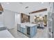 Bright kitchen featuring a center island with sink and wine cooler, with a view to the dining room at 1119 Highland S St, St Petersburg, FL 33701