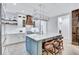 Updated kitchen with a large island, white cabinets, a wooden range hood, and modern lighting at 1119 Highland S St, St Petersburg, FL 33701