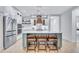Beautiful kitchen with stainless steel appliances, white cabinets, an island, and wooden stools at 1119 Highland S St, St Petersburg, FL 33701
