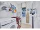 Functional laundry room equipped with a washer, dryer, shelving, and natural light at 1119 Highland S St, St Petersburg, FL 33701