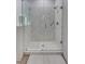 Walk-in shower featuring bright white marble style tile and a glass enclosure at 1119 Highland S St, St Petersburg, FL 33701