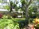 Secluded backyard featuring lush landscaping, swing, and privacy fence at 1212 Rosewood St, Largo, FL 33770