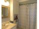 Bright bathroom featuring a vanity, mirror, and a shower with a patterned curtain at 1212 Rosewood St, Largo, FL 33770