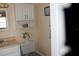 Bathroom featuring a single sink vanity with an overhead mirror and storage cabinet above the toilet at 1212 Rosewood St, Largo, FL 33770