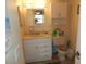 Bathroom featuring vanity with drawers, mirror, and nearby toilet at 1212 Rosewood St, Largo, FL 33770