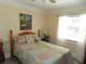Charming bedroom with wood trim, patchwork quilt, and sun-filled window at 1212 Rosewood St, Largo, FL 33770