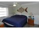 Charming bedroom with ceiling fan, decorative fish art, and modern furnishings at 1212 Rosewood St, Largo, FL 33770