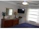 Bedroom featuring a dresser, mirror, and a view of the window providing natural light at 1212 Rosewood St, Largo, FL 33770