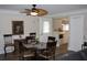 Cozy dining area featuring a round table, decorative ceiling fan, and adjacent kitchen view at 1212 Rosewood St, Largo, FL 33770