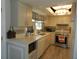 Efficient kitchen features tiled backsplash, stainless steel appliances, and skylight at 1212 Rosewood St, Largo, FL 33770