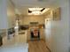 Efficient kitchen features tiled backsplash, white appliances, and modern light fixture at 1212 Rosewood St, Largo, FL 33770