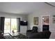 Living room with a tv, reclining chair and sliding glass doors to the backyard at 1212 Rosewood St, Largo, FL 33770