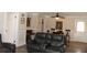 This neutral living room is open to a dining area and features dark leather sofas at 1212 Rosewood St, Largo, FL 33770
