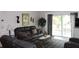 Comfortable living room with reclining leather sofas and sliding glass doors to the backyard at 1212 Rosewood St, Largo, FL 33770