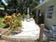 Inviting patio area for outdoor dining and relaxation amidst colorful landscaping at 1212 Rosewood St, Largo, FL 33770