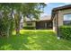 Expansive backyard showcasing lush green grass, mature trees, and partial view of home's rear at 13821 Moonstone Canyon Dr, Riverview, FL 33579