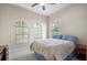 Bedroom with arched windows, ceiling fan, and natural light with a blue bed at 13821 Moonstone Canyon Dr, Riverview, FL 33579