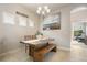 Charming dining area featuring a wooden table with bench seating and plantation shutters at 13821 Moonstone Canyon Dr, Riverview, FL 33579