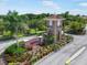 Community entrance with stone tower, manicured landscaping and signage that reads 