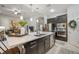 Open concept kitchen with stainless steel appliances, a kitchen island, and views of the living area at 13821 Moonstone Canyon Dr, Riverview, FL 33579