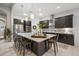 Spacious kitchen featuring dark cabinetry, stainless steel appliances, and an island with seating at 13821 Moonstone Canyon Dr, Riverview, FL 33579