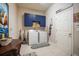 Laundry room with blue storage cabinets, a front-load washer and dryer, and a sign at 13821 Moonstone Canyon Dr, Riverview, FL 33579