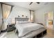 Comfortable main bedroom featuring neutral tones, ensuite bath access, and a ceiling fan at 13821 Moonstone Canyon Dr, Riverview, FL 33579