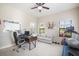 Office with a ceiling fan, natural light from windows, a desk, and workout equipment at 13821 Moonstone Canyon Dr, Riverview, FL 33579