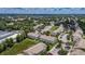An aerial view of a condominium complex in a lush, green community with ample parking space at 13905 Abbey Ln, Largo, FL 33771