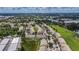 Aerial view showcases townhome community and convenient location surrounded by trees, parks, and shops at 13905 Abbey Ln, Largo, FL 33771