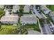 Aerial view of the property highlighting the landscaping, parking, and nearby waterway at 13905 Abbey Ln, Largo, FL 33771
