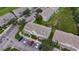 Aerial view of the property shows townhomes surrounded by green spaces, parking, and lush landscaping at 13905 Abbey Ln, Largo, FL 33771
