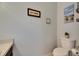 Powder room with standard toilet and decorative wall art at 13905 Abbey Ln, Largo, FL 33771