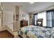 Bedroom with multiple windows providing natural lighting and traditional wooden decor at 13905 Abbey Ln, Largo, FL 33771